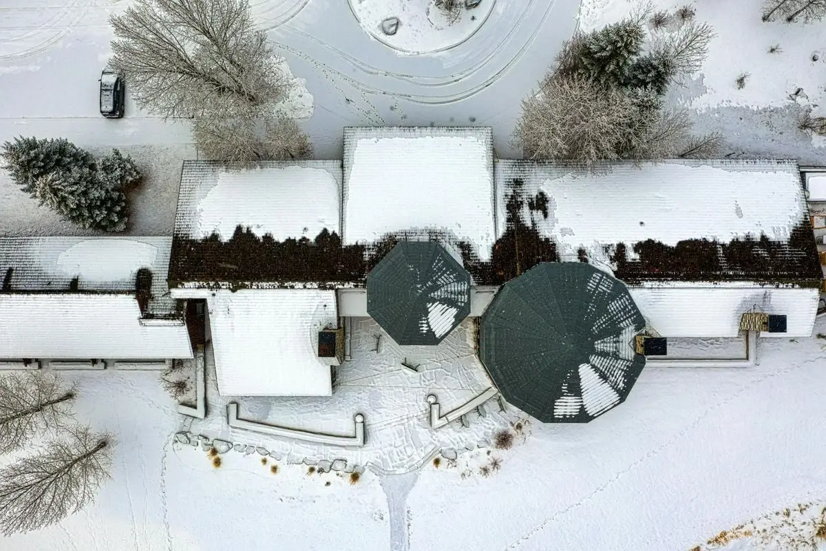 Aerial shot of snow-covered homes and landscape in Swan Valley, Idaho during winter.