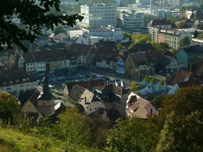 A scenic view capturing a Bavarian townscape with colorful buildings, trees, and urban architecture in autumn.