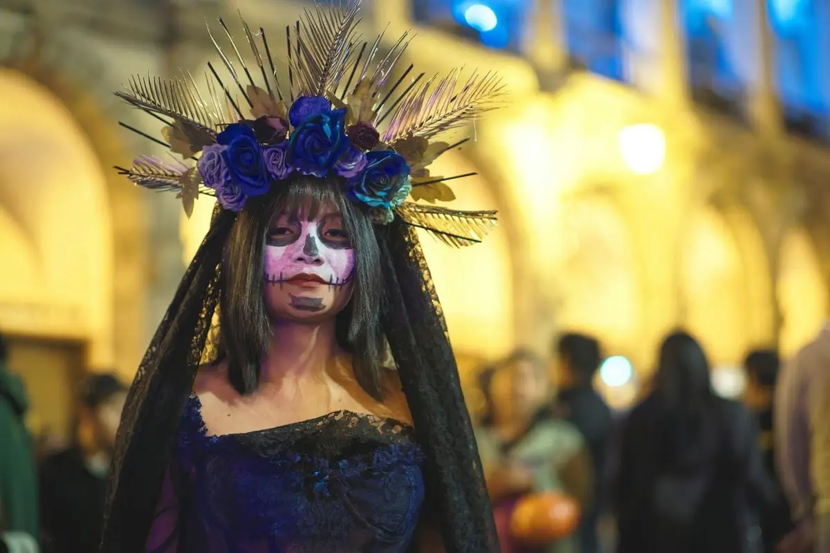 Vibrant Day of the Dead costume with floral headdress in Arequipa, Peru, during festival.