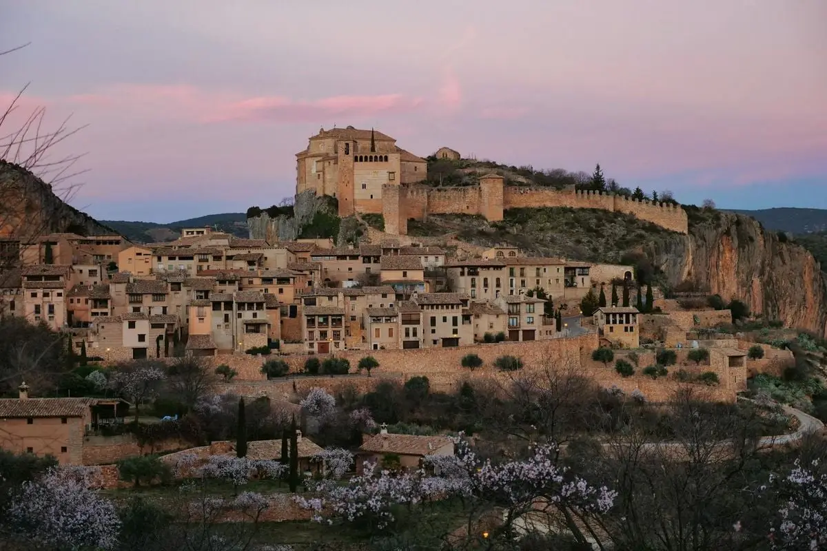 Stunning twilight view of Alquézar, Spain, showcasing ancient architecture and scenic landscapes.