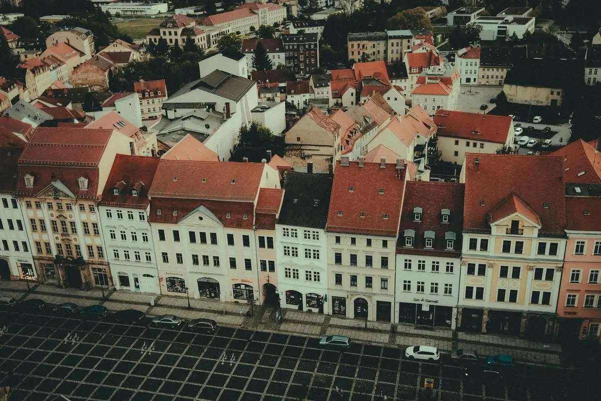Aerial view of charming historic buildings in an old European town with red rooftops.