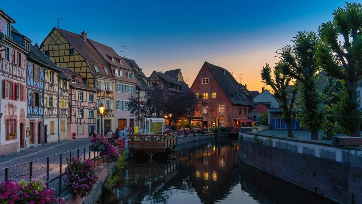 Picturesque canal view of Colmar's half-timbered houses at sunset, France.
