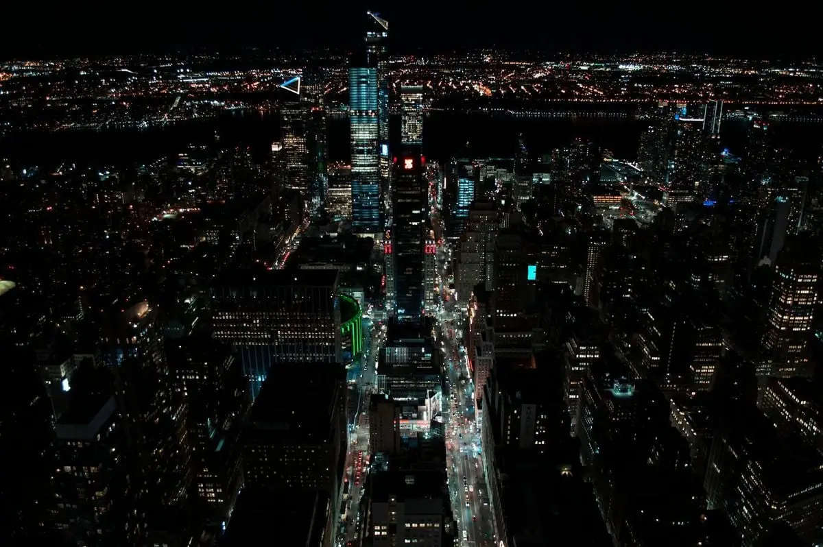 A breathtaking aerial view of New York City at night, featuring vibrant city lights and skyscrapers.