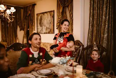 Family gathered indoors for a joyful holiday celebration with festive decorations.