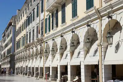 Beautiful traditional architecture with arched facades in Corfu, Greece under a bright summer sky.