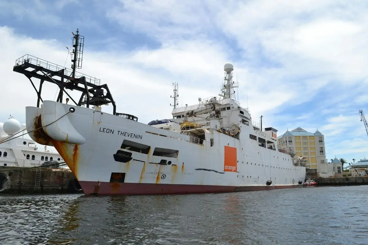 The cable-laying vessel Leon Thevenin moored at the bustling harbor of Cape Town, South Africa.