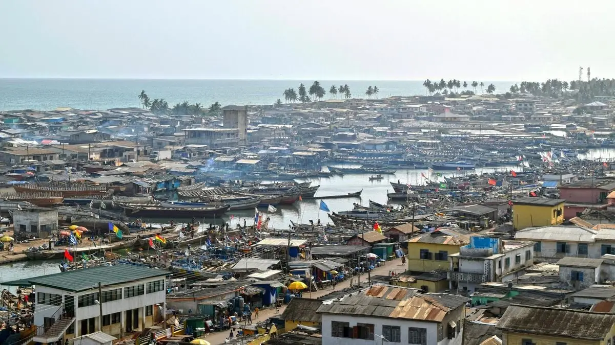 A scenic aerial view of Elmina's bustling fishing port and town in Ghana.