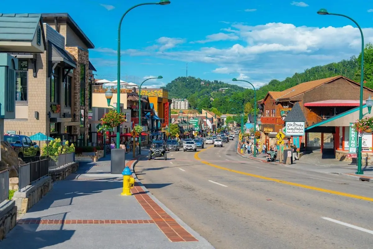 Vibrant street scene on a sunny day in Gatlinburg, showcasing shops and scenic views.