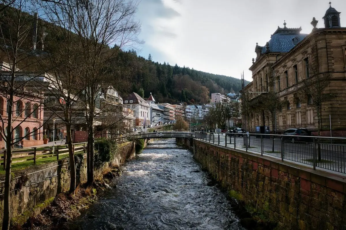 Picturesque view of canal and historic buildings in Bad Wildbad, Germany.