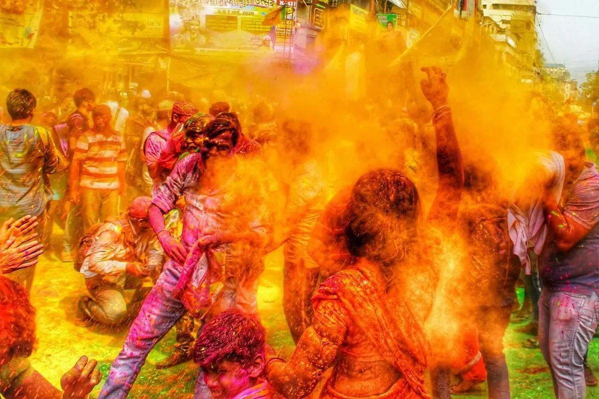 Captured moment of Holi festival in Kolkata with people joyfully throwing colored powders.