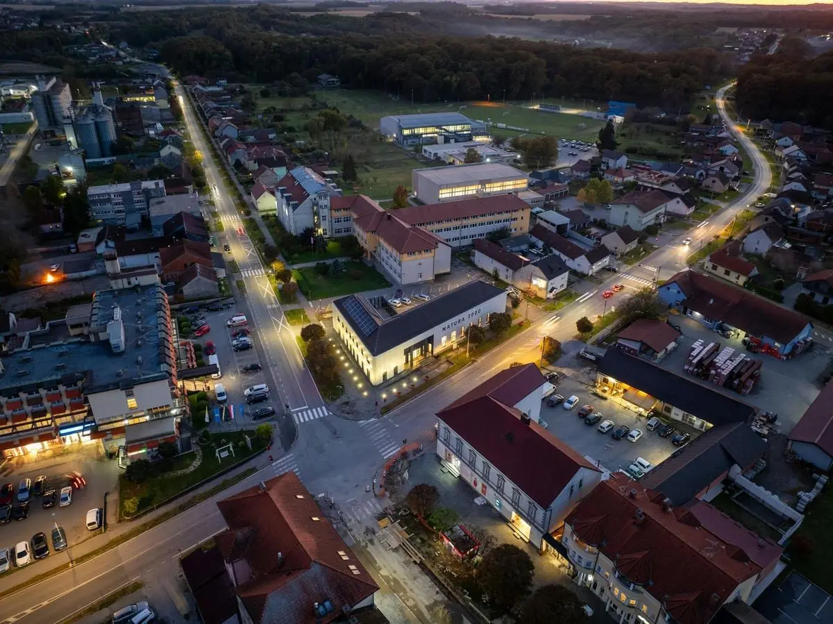 Stunning aerial view of Garešnica, Croatia illuminated at twilight, capturing vibrant streets and architecture.