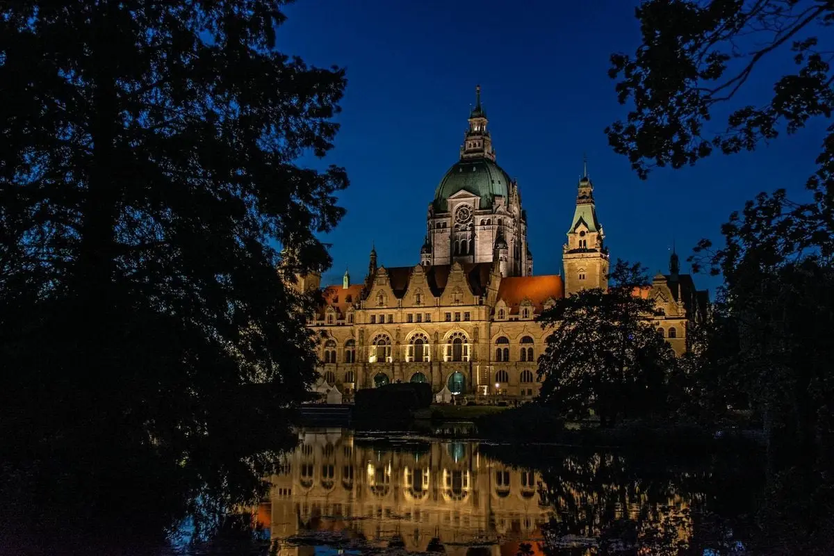 Stunning night view of the Neo-Renaissance New Town Hall in Hannover, reflected in a pond.