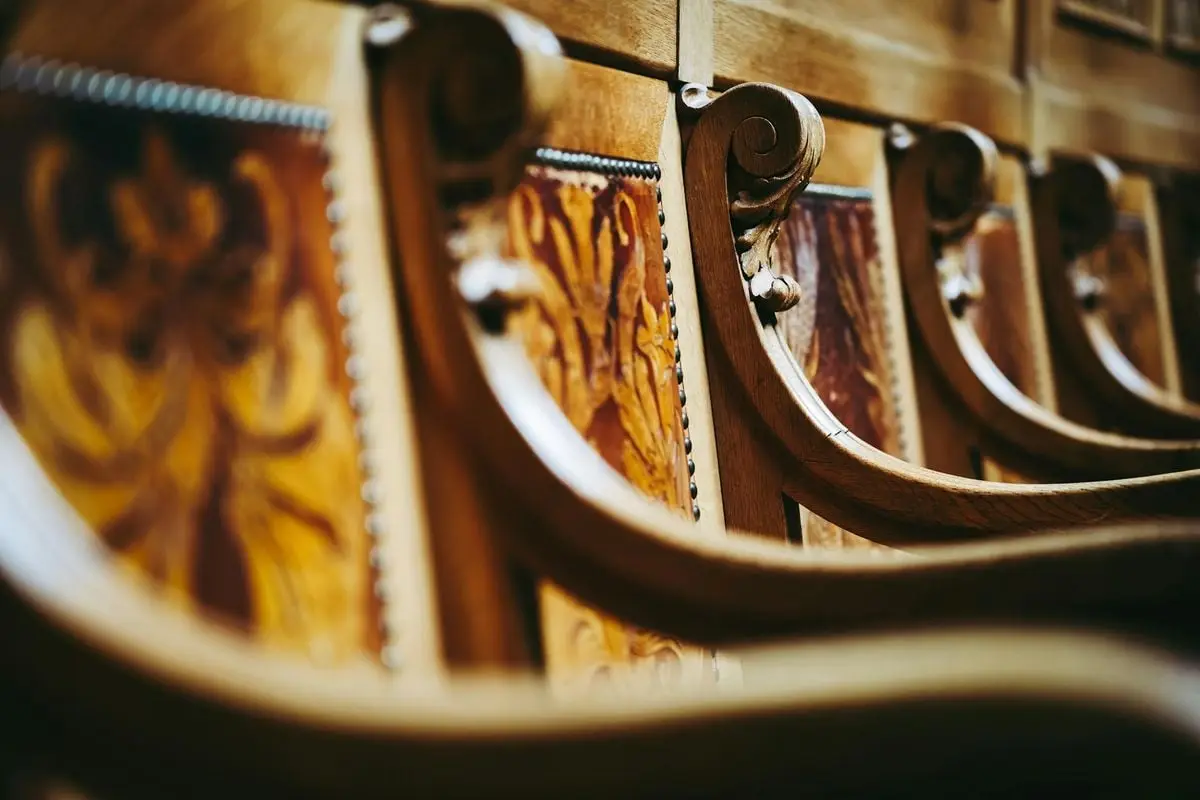 Close-up of ornate wooden chairs inside the Swiss Parliament building in Bern, Switzerland.