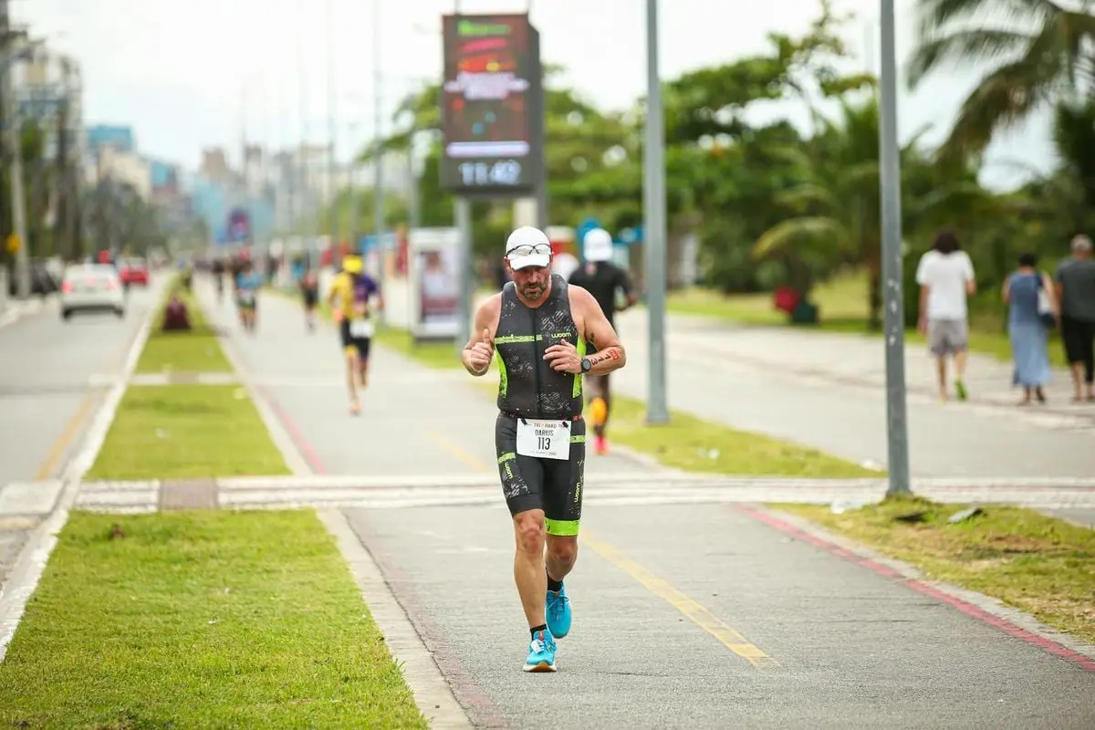 Athlete running a marathon on a city street, showcasing fitness and determination.