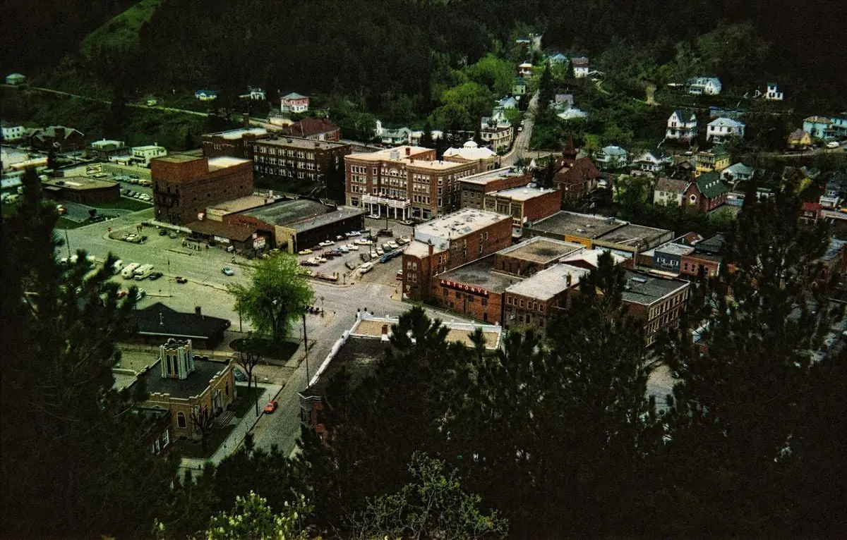 Scenic aerial view of historic Lead, South Dakota featuring classic architecture and lush greenery.