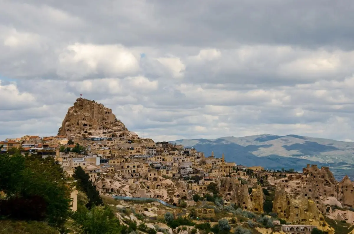 A stunning view of the ancient rock formations and town in Cappadocia, Turkey.