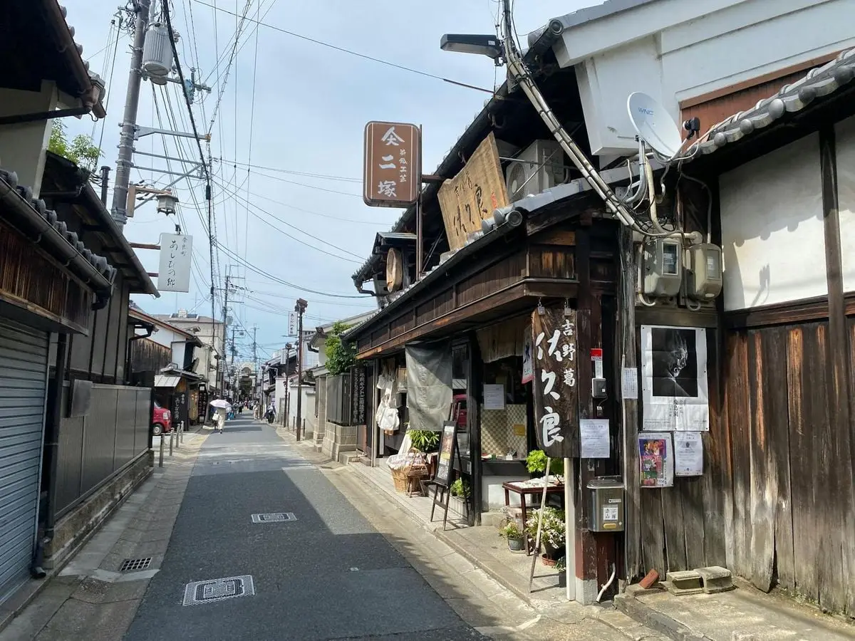 Scenic view of a narrow street in Ikaruga, Nara, Japan with traditional wooden houses and shops.