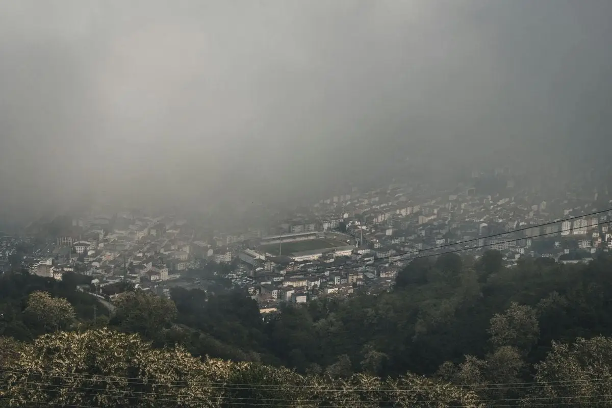 A captivating aerial view of Ordu, Turkey shrouded in dense fog with urban landscape below.