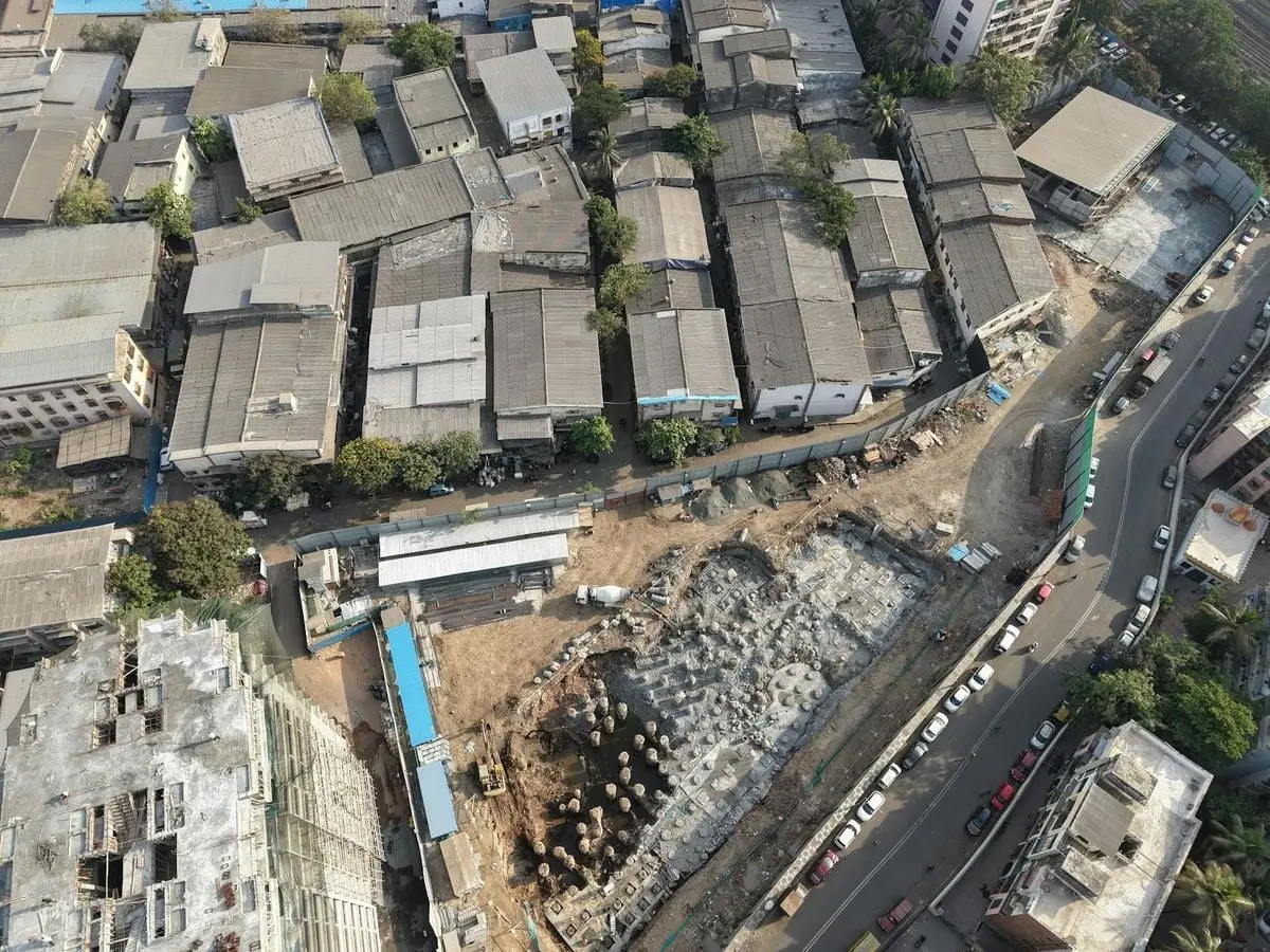 Bird's-eye view of construction and rooftops in Mumbai, India.