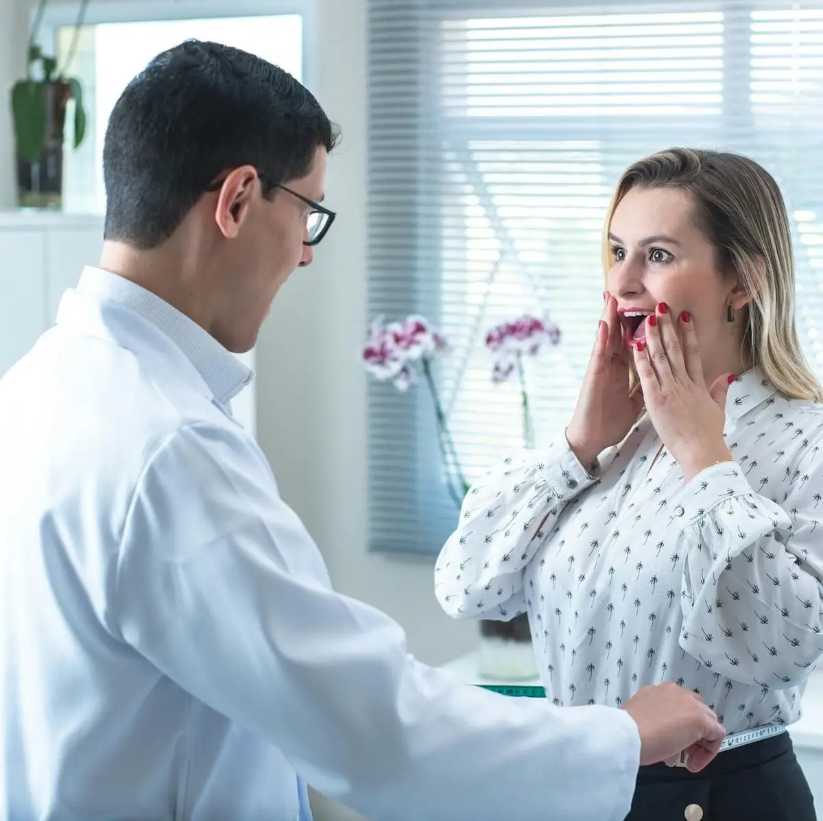 Woman surprised by results in a medical consultation with doctor measuring her waist.