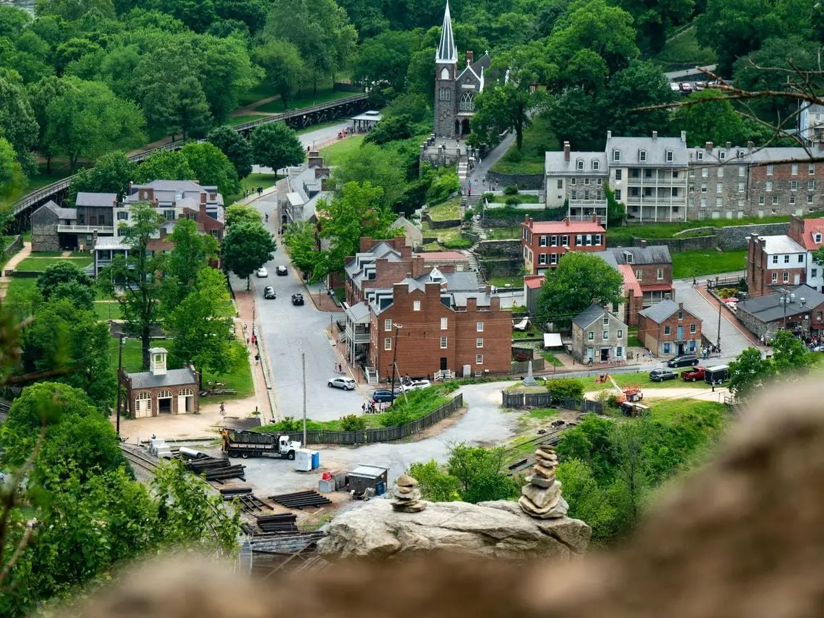 Aerial view of Harpers Ferry, showcasing historic buildings surrounded by lush greenery.