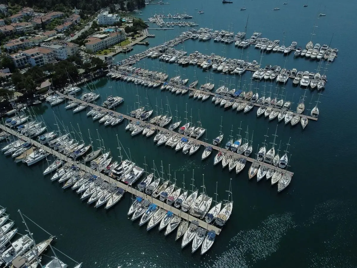 Stunning aerial view of a marina filled with sailboats in Turkey, showcasing a tranquil harbor setting.