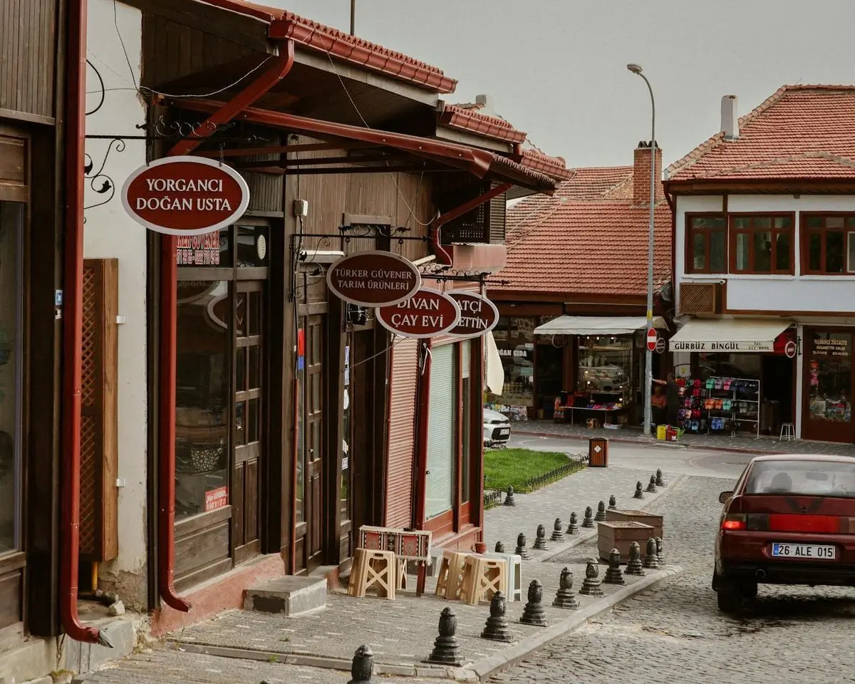 Historic street scene featuring local shops with Turkish signage and quaint architecture.
