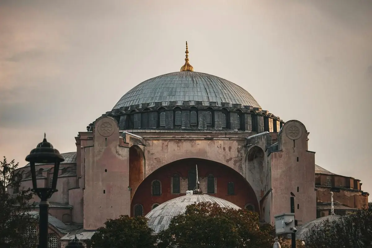 The majestic dome of Hagia Sophia under a vibrant sunset sky, Istanbul.
