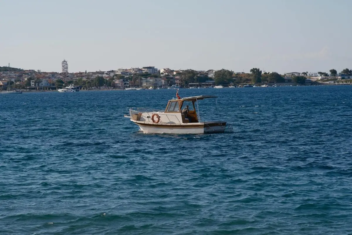 A tranquil motorboat on the Aegean Sea near the coastal town of Foça, İzmir, Türkiye, offering a perfect seascape.