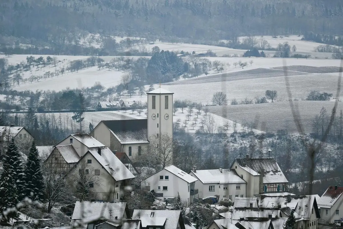 Snow-covered village in Auenwald, Germany, showcasing picturesque winter scenery.