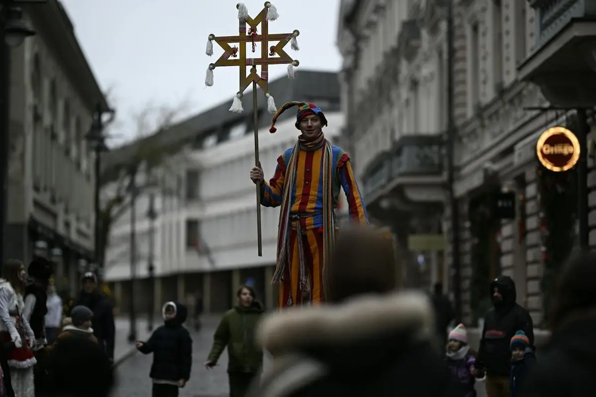 Stilt walker in costume at Vilnius street festival, capturing urban celebrations.