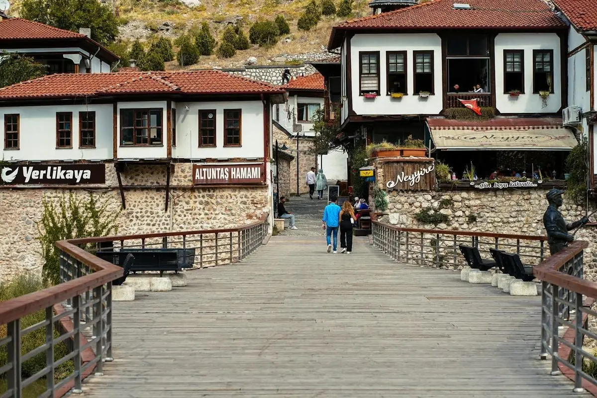 Scenic view of a footbridge leading to traditional Ottoman-style buildings in Amasya, Turkey.