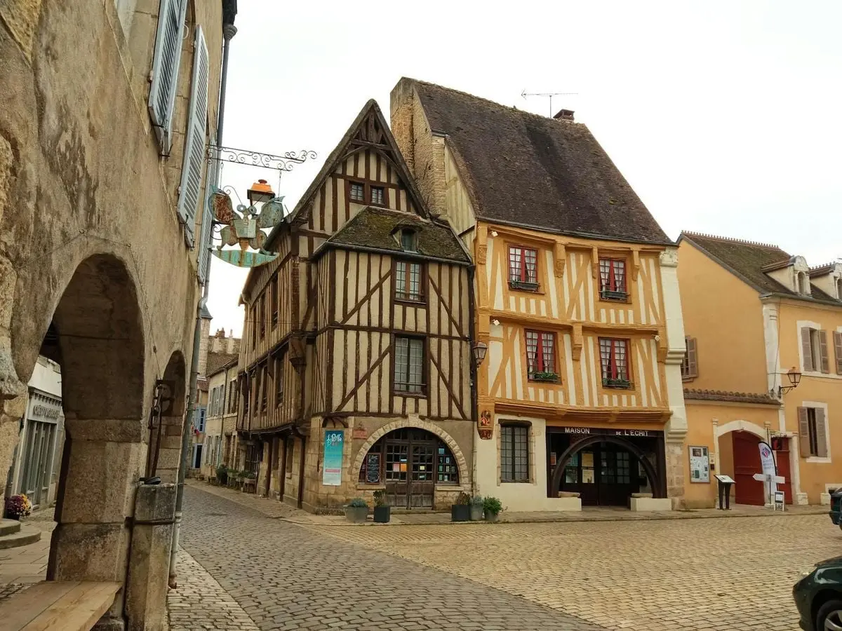 Charming medieval architecture in Noyers-sur-Serein, France, showcasing traditional timber-framed houses.
