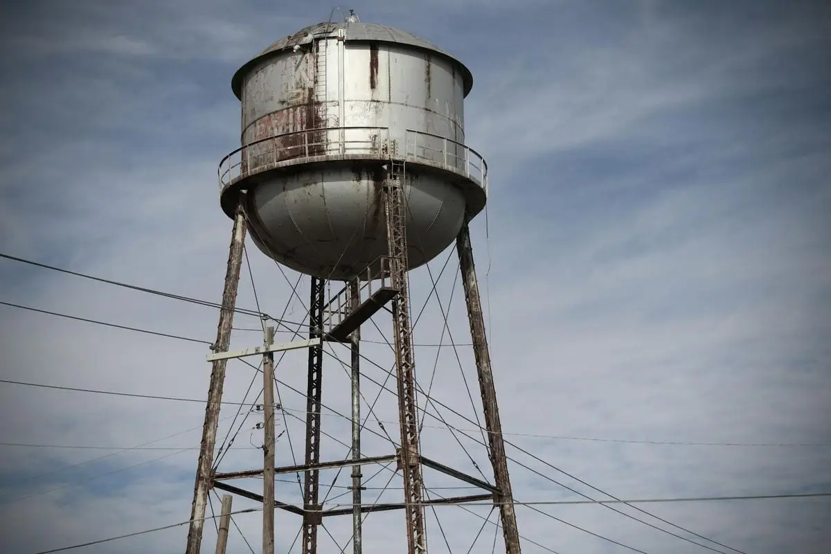 A rustic water tower with a cloudy sky backdrop in Rankin, TX, capturing industrial charm.