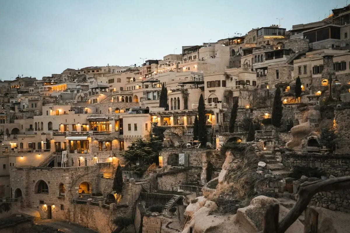 Beautiful view of traditional stone houses illuminated at dusk in a Turkish town.