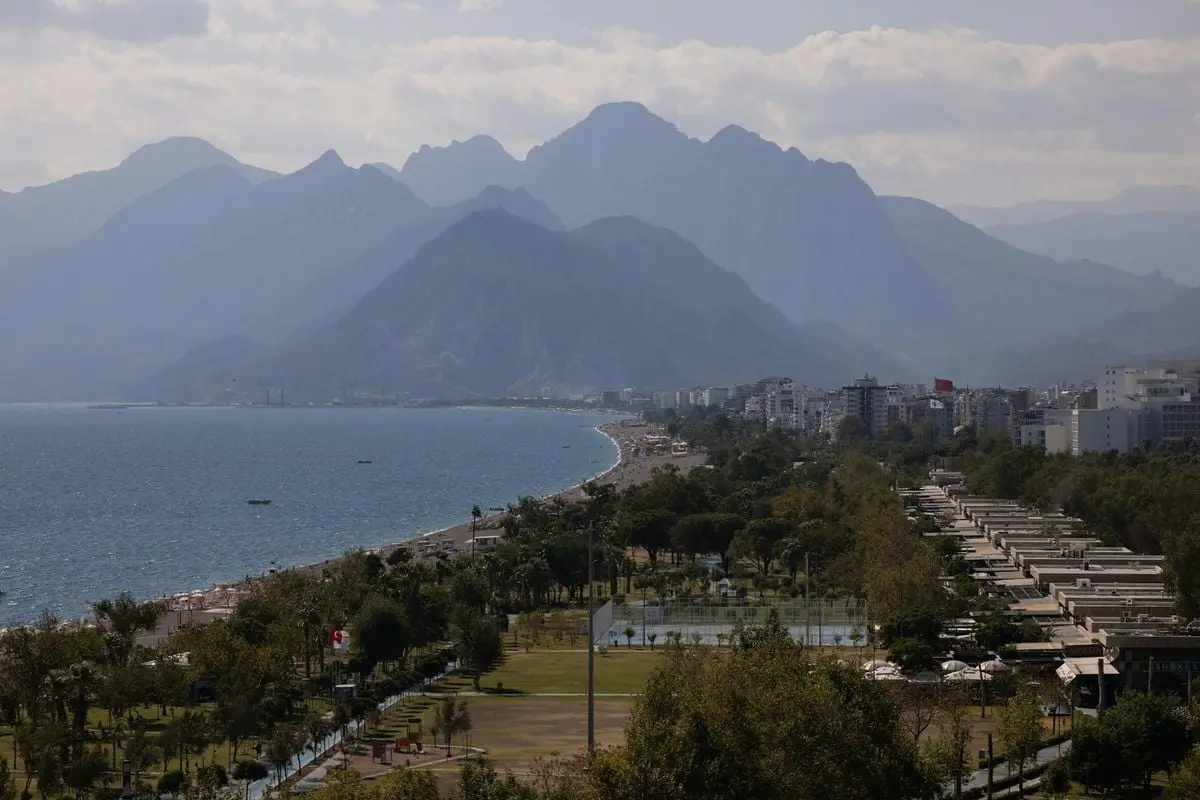 Breathtaking view of Antalya's coastline with majestic mountains and urban landscape.
