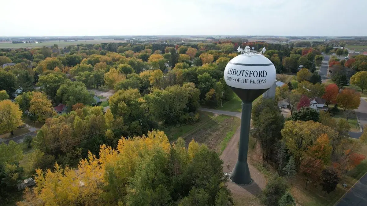 A scenic aerial view of Abbotsford's water tower amidst colorful autumn foliage.
