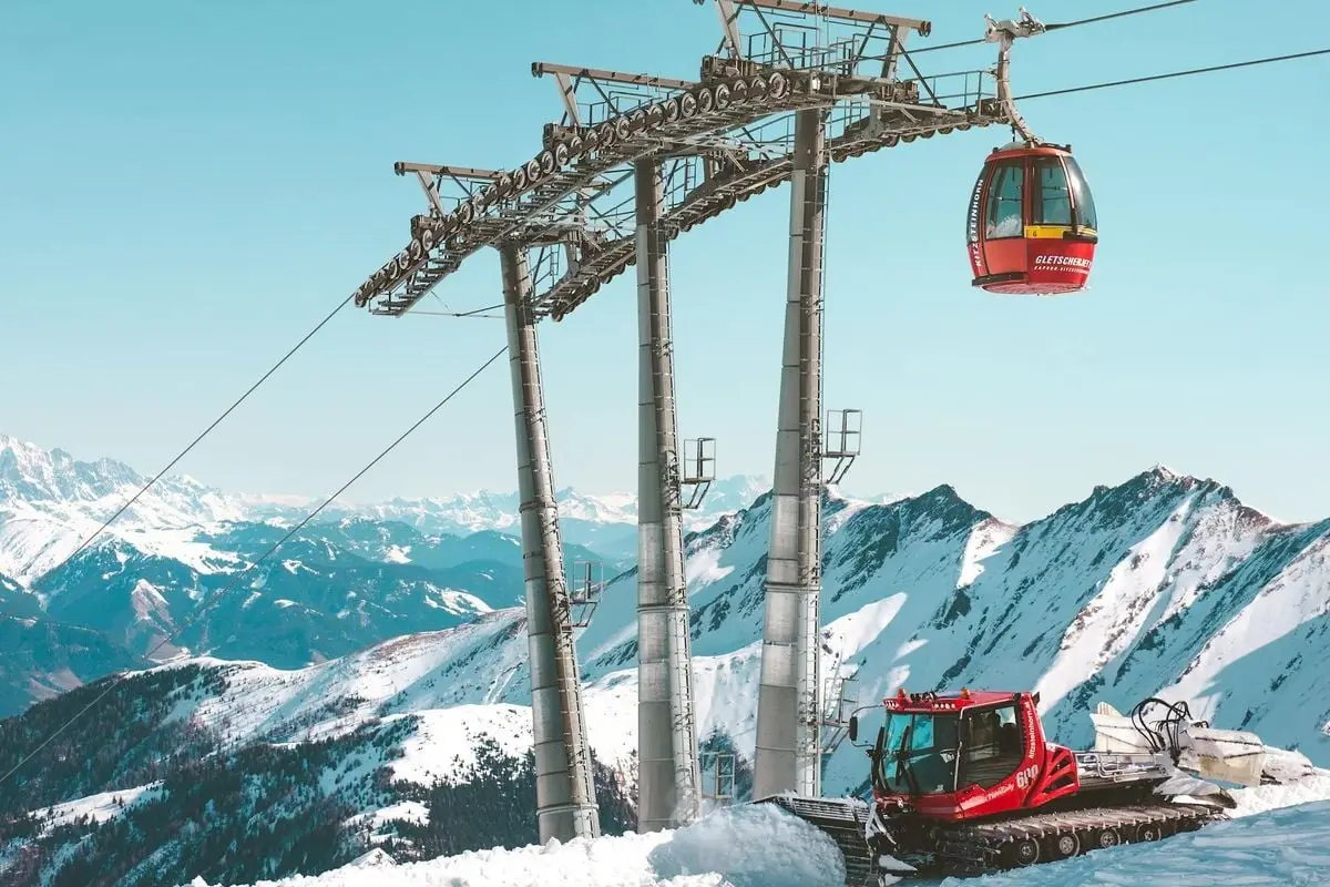 Scenic view of a ski resort cable car and snowplow in Zell am See, Austria.