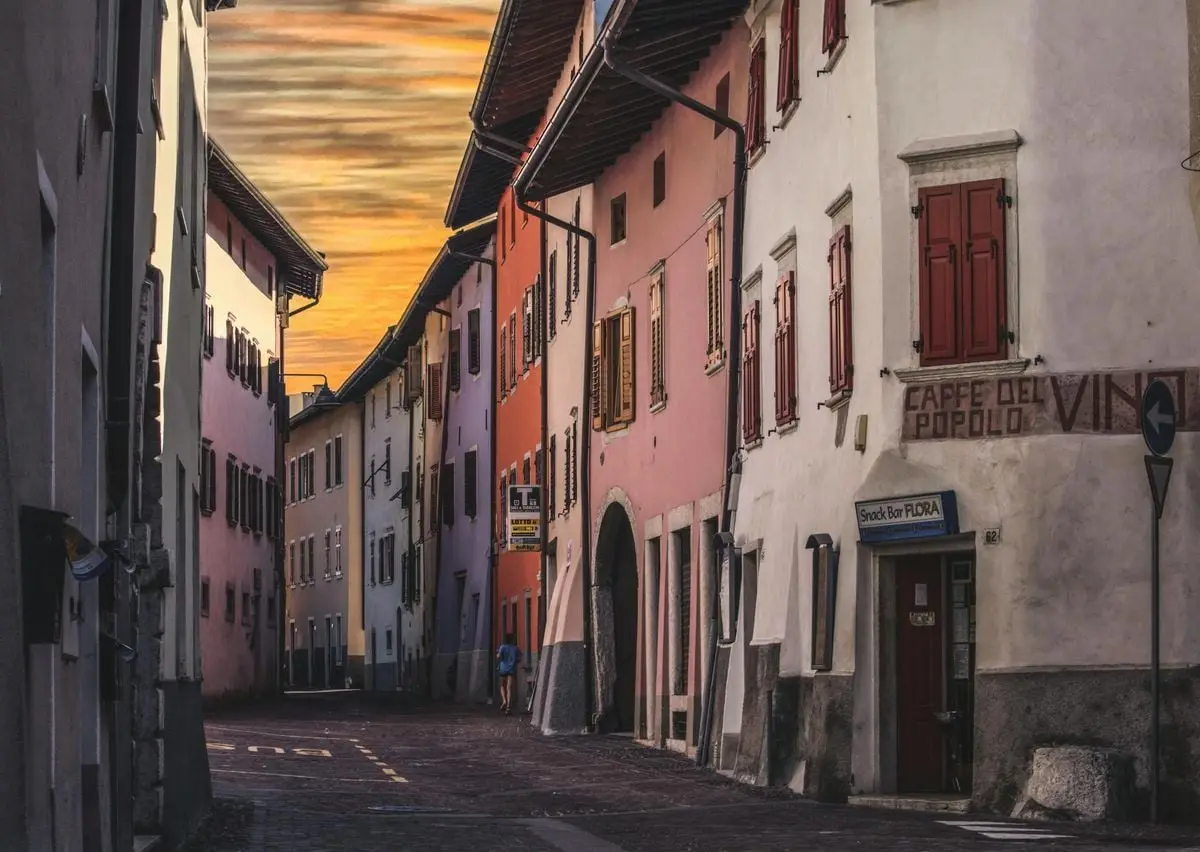 Picturesque view of a quaint old town street with colorful facades during a beautiful sunset.