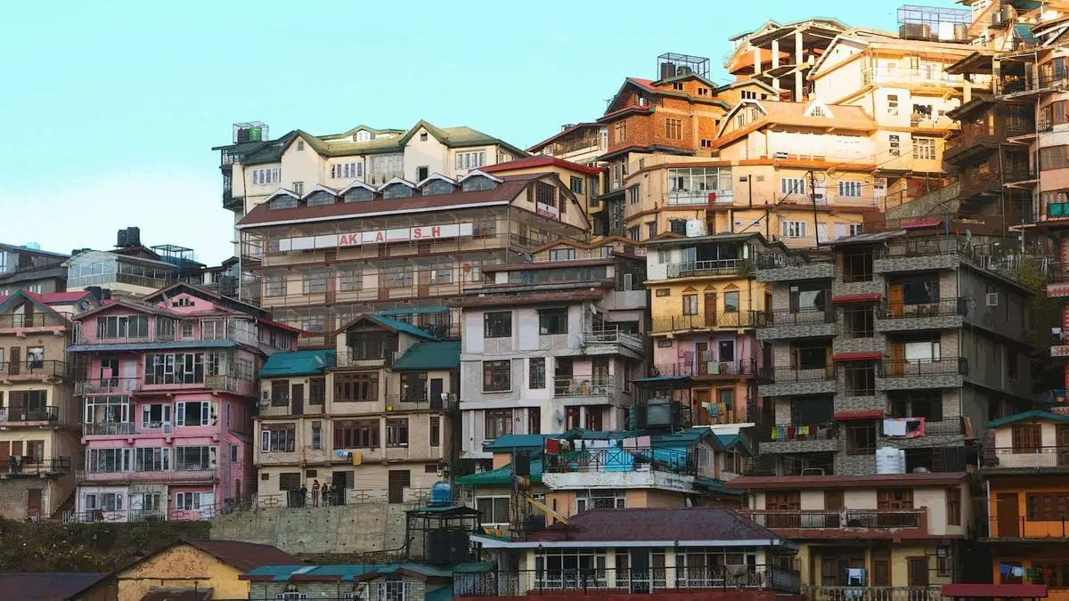 Vibrant and diverse residential buildings in Shimla, India, showcasing unique architectural styles.