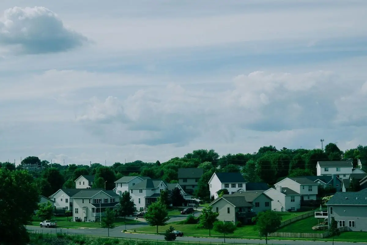 Picturesque suburban houses beneath a blue sky with clouds in Wisconsin.