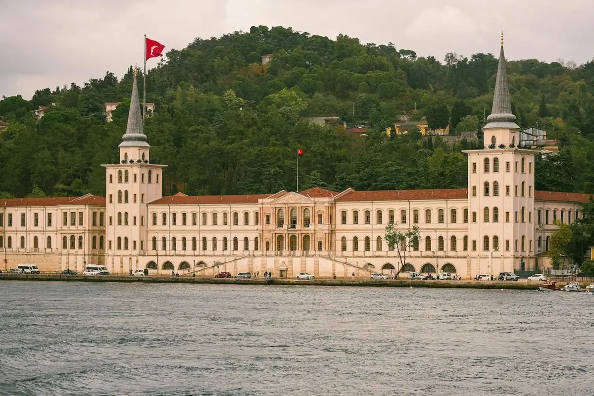 Kuleli Military High School along Istanbul waterfront with Turkish flag.