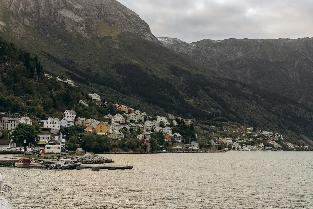 Charming village in Norway nestled between the sea and majestic mountains. A serene and picturesque landscape.