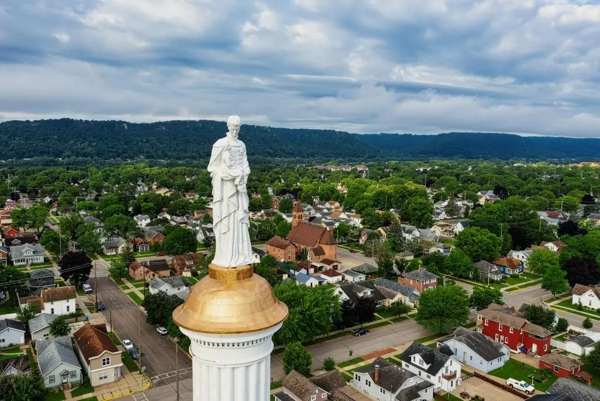 Aerial view of a historic statue and vibrant neighborhood in Winona, Minnesota.