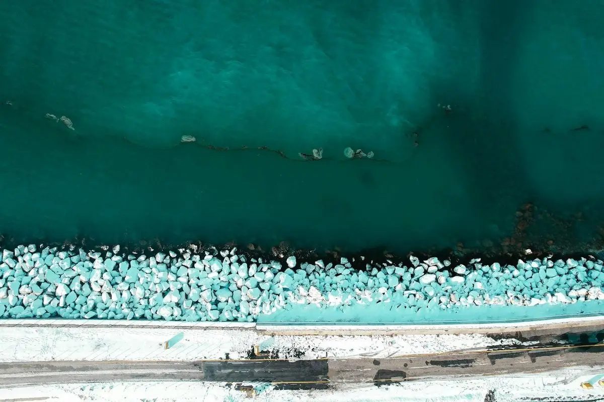 Stunning aerial view of icy coastline by the sea in Van, Türkiye, showcasing winter beauty.