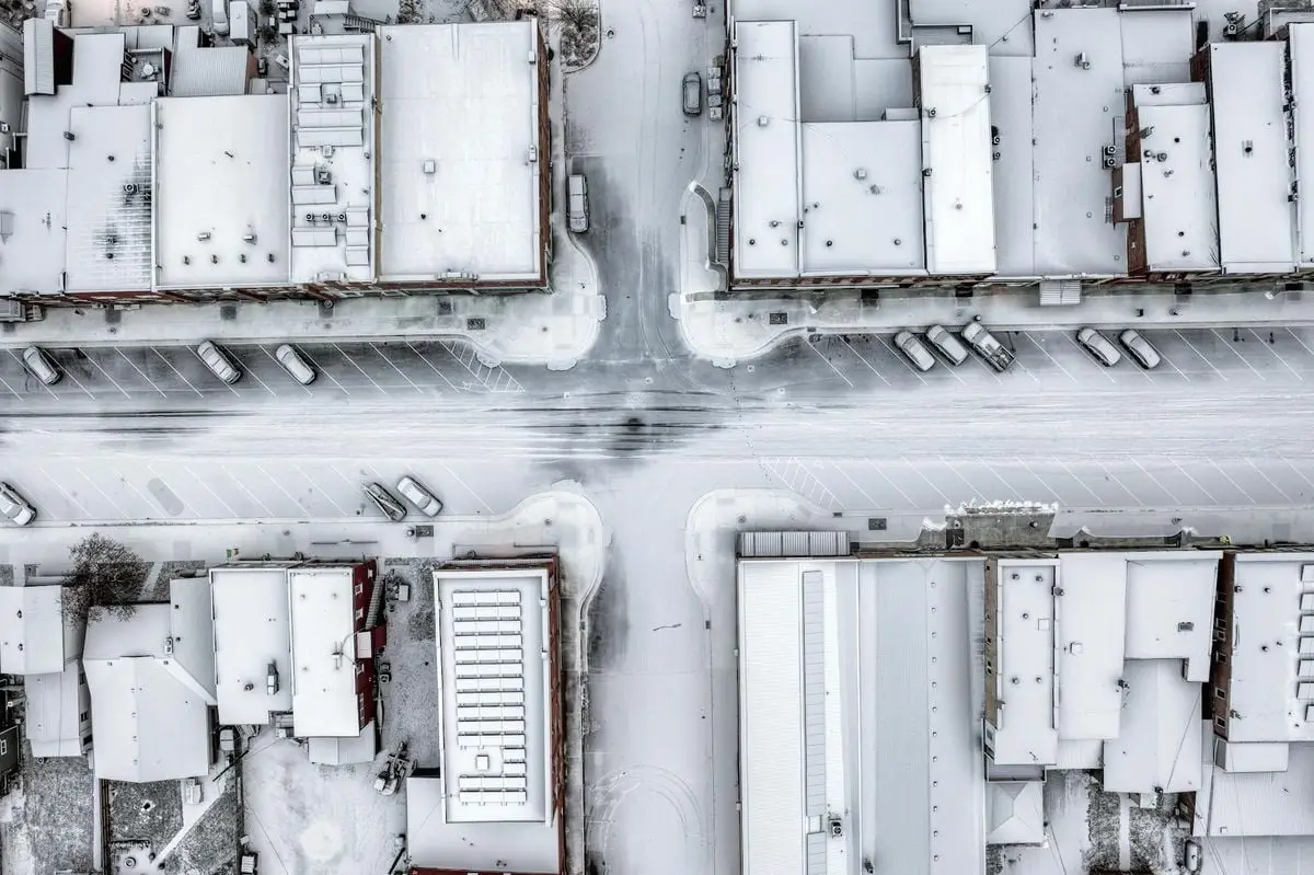 Aerial view of snow-covered streets and buildings in a wintery urban setting in Wabasha, MN.