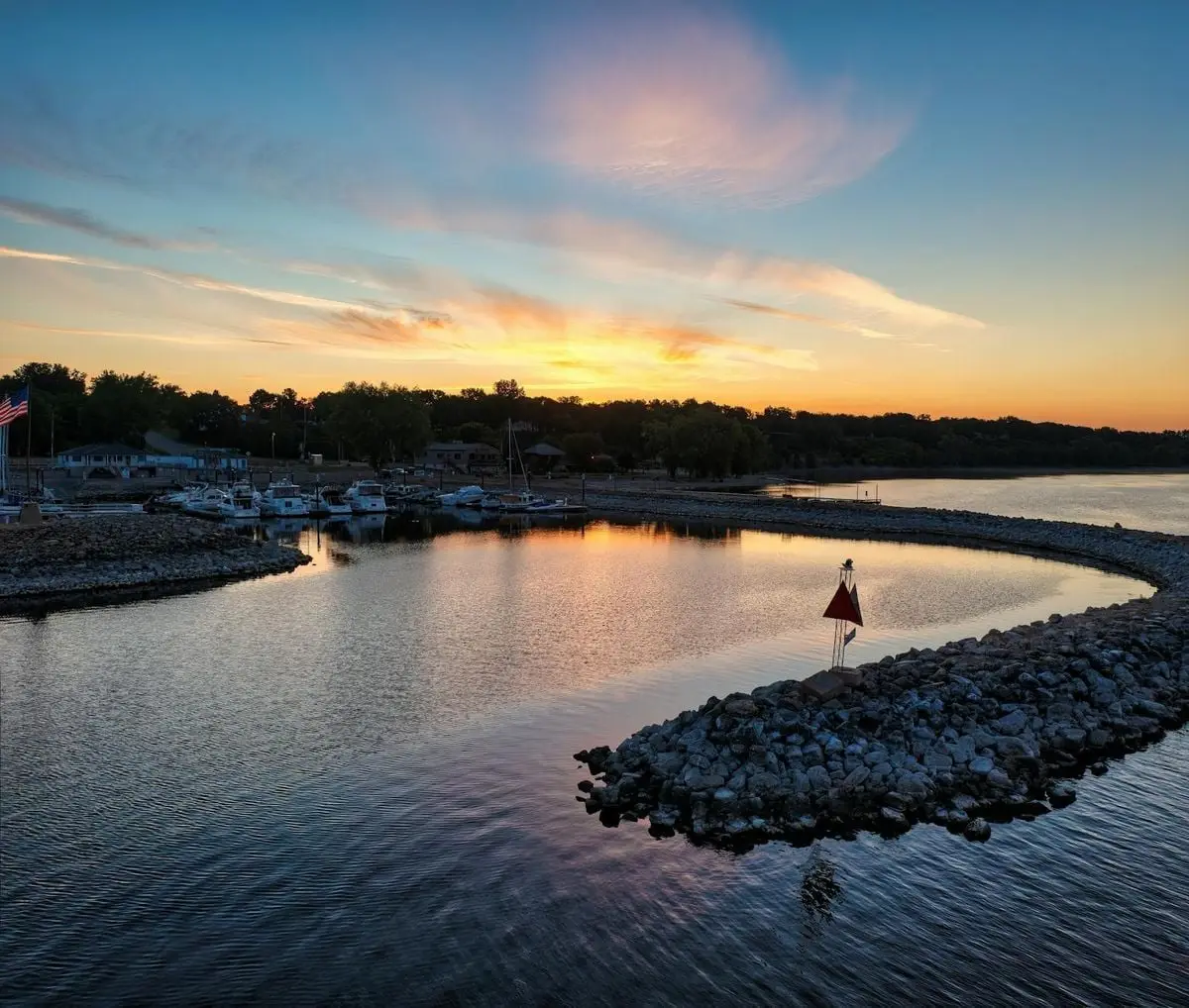 A tranquil sunrise over the marina in Pepin, WI, capturing the reflections on calm water.