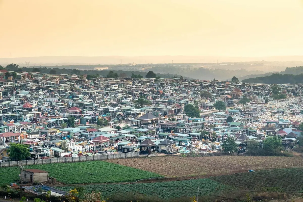 A scenic aerial view of a densely populated urban settlement during sunset.
