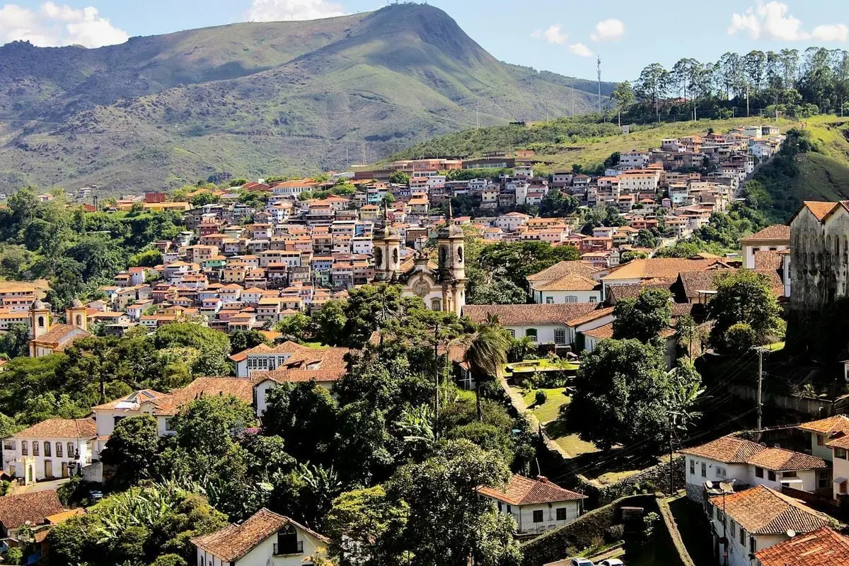 Breathtaking landscape of Ouro Preto, Brazil, with historic architecture nestled in lush hills.