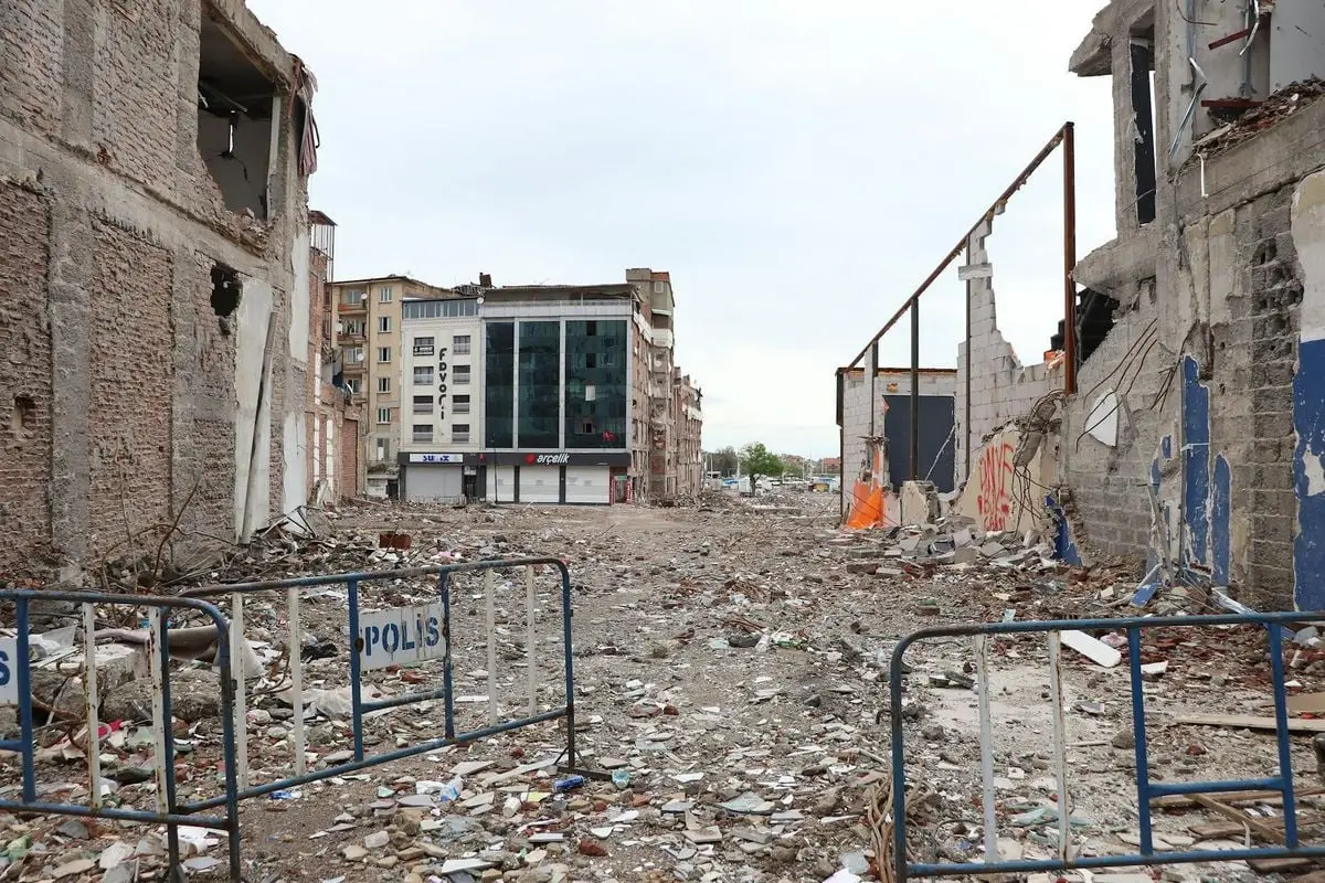 A city street filled with rubble after a natural disaster, showcasing urban devastation.